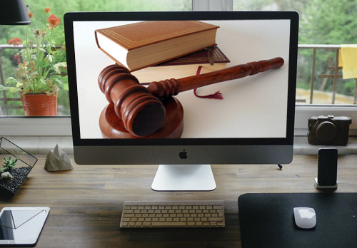 Gavel and Law Books on Computer Screen